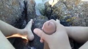 SITTING ON ROCK BY THE BEACH AND WANKING